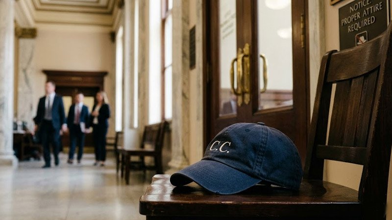 Casual hat set aside before entering a courtroom